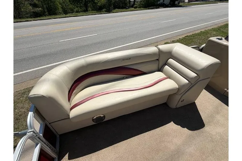 Slide: The Image of 2012 Sweetwater Premium Edition 220 DL boat seat with beige and red upholstery. - 12