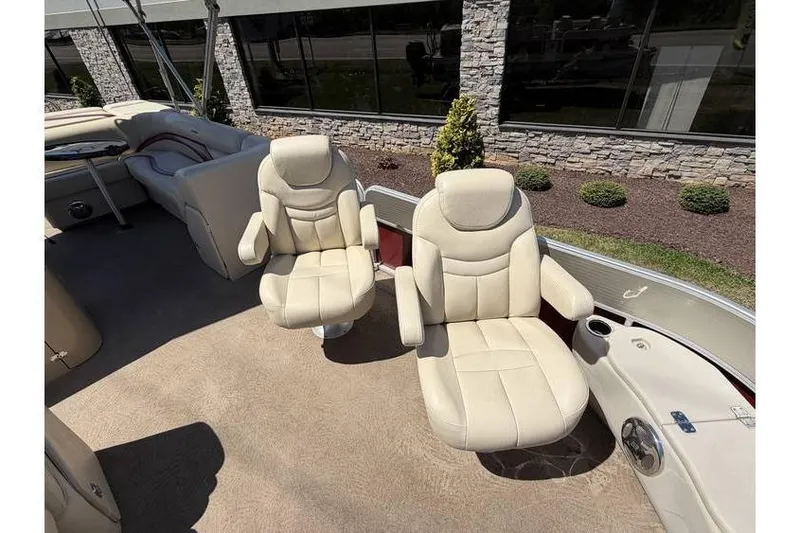 Slide: The Image of 2012 Sweetwater Premium Edition 220 DL boat interior with plush beige seating. - 13