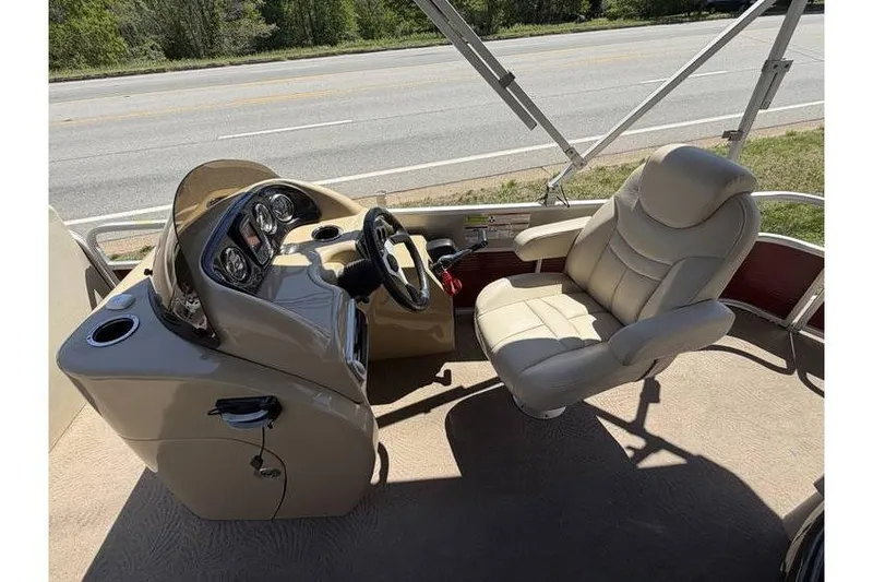 Slide: The Image of Captain's seat and helm of a 2012 Sweetwater Premium Edition 220 DL pontoon boat. - 15