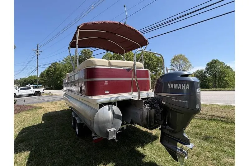 Slide: The Image of 2012 Sweetwater Premium Edition 220 DL pontoon boat with Yamaha outboard motor, parked on grass. - 8