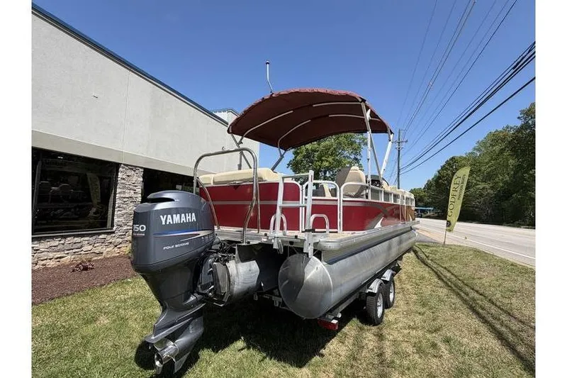 Slide: The Image of 2012 Sweetwater Premium Edition 220 DL pontoon boat with Yamaha 150 engine, parked outdoors. - 9