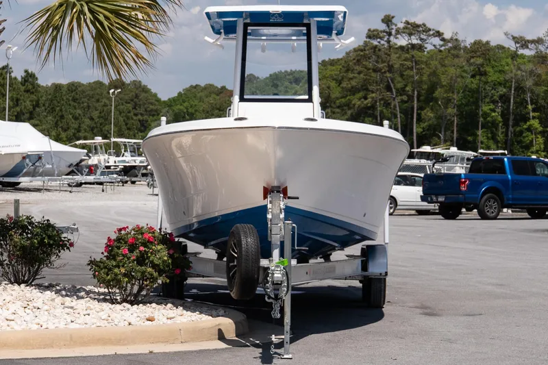Slide: The Image of 2026 Blazer Bay Makaira 2600 boat on trailer in sunny marina setting. - 3