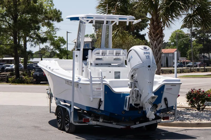 Slide: The Image of 2026 Blazer Bay Makaira 2600 boat with Yamaha 350 engine on trailer, parked outdoors. - 4