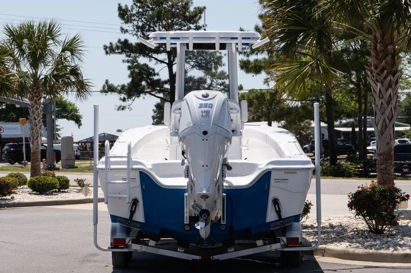 Slide: The Image of 2026 Blazer Bay Makaira 2600 boat on trailer, parked near palm trees. - 5