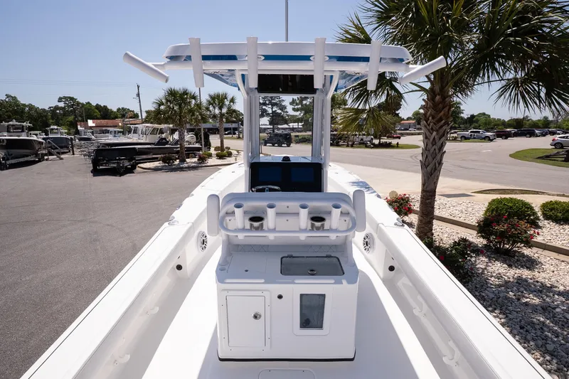 Slide: The Image of 2026 Blazer Bay Makaira 2600 boat with center console, docked near palm trees. - 7