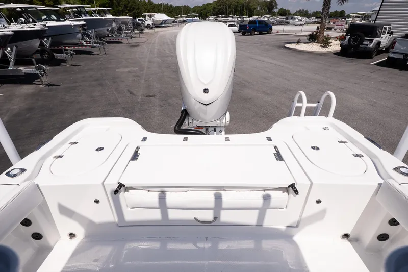 Slide: The Image of 2026 Blazer Bay Makaira 2600 boat stern view with outboard motor in a marina. - 8