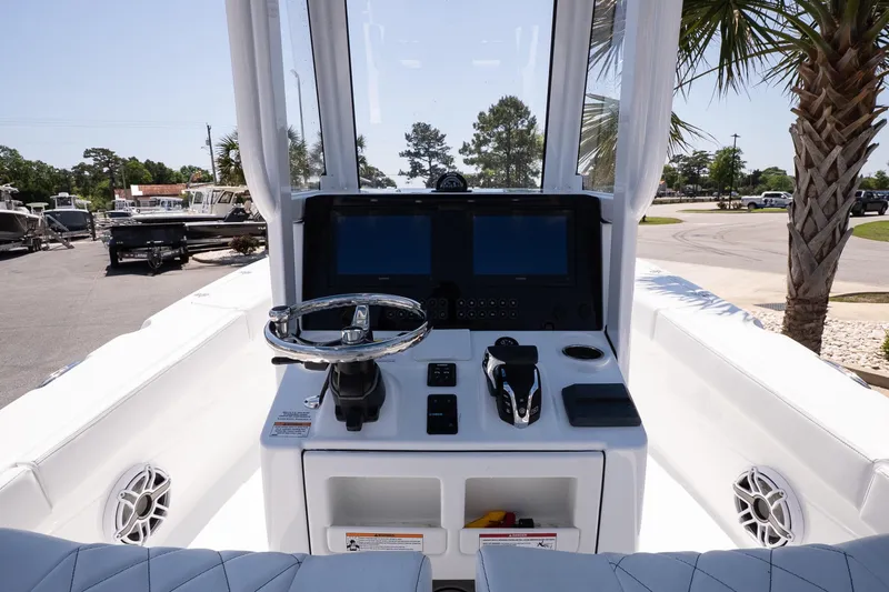 Slide: The Image of 2026 Blazer Bay Makaira 2600 boat dashboard with steering wheel and control panel. - 9