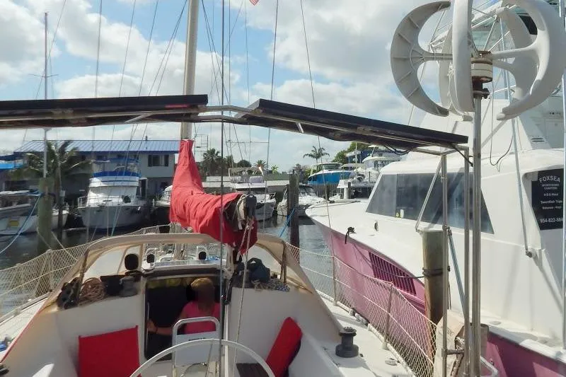 Slide: The Image of Sailboat Etap 38i, 1997 model, docked at marina with solar panels and wind turbine. - 11