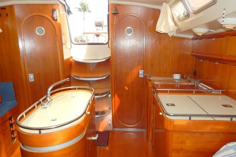 Slide: The Image of Interior of a 1997 Etap 38i sailboat with wooden cabinetry and modern fixtures. - 19