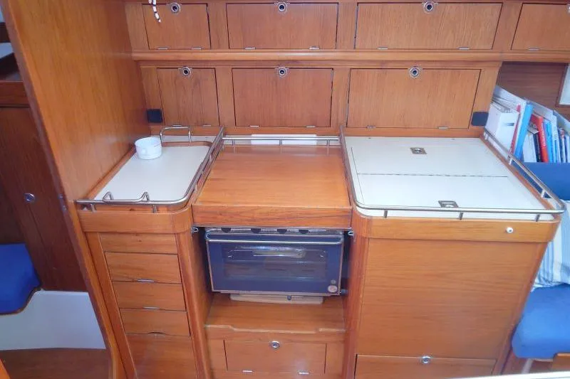 Slide: The Image of Interior of a 1997 Etap 38i yacht kitchen with wooden cabinetry and stove. - 22