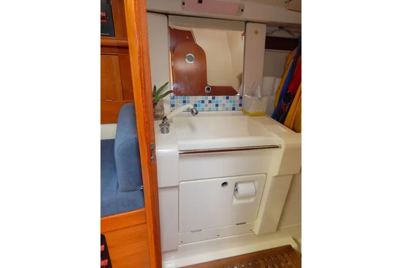 Slide: The Image of Interior of 1997 Etap 38i yacht featuring a compact bathroom sink area. - 24