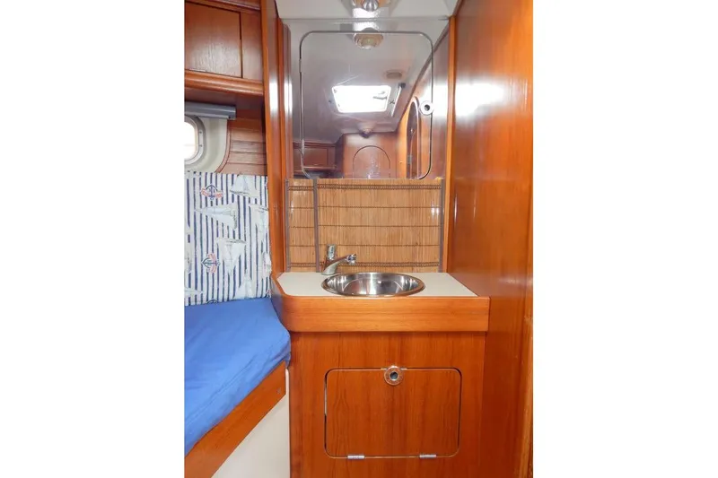Slide: The Image of Interior of 1997 Etap 38i yacht with wooden cabinetry and compact sink area. - 25
