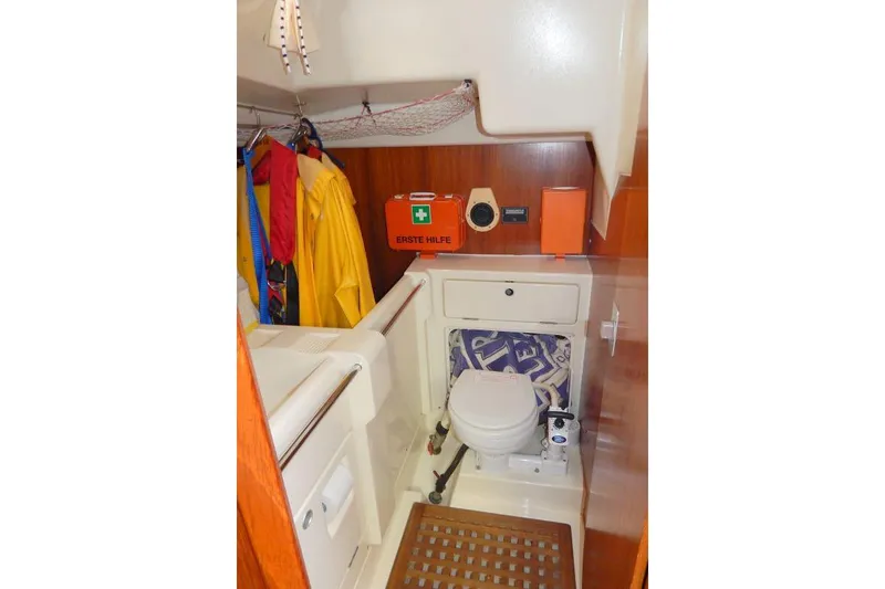 Slide: The Image of Interior of 1997 Etap 38i sailboat bathroom with toilet, first aid kit, and hanging rain gear. - 26