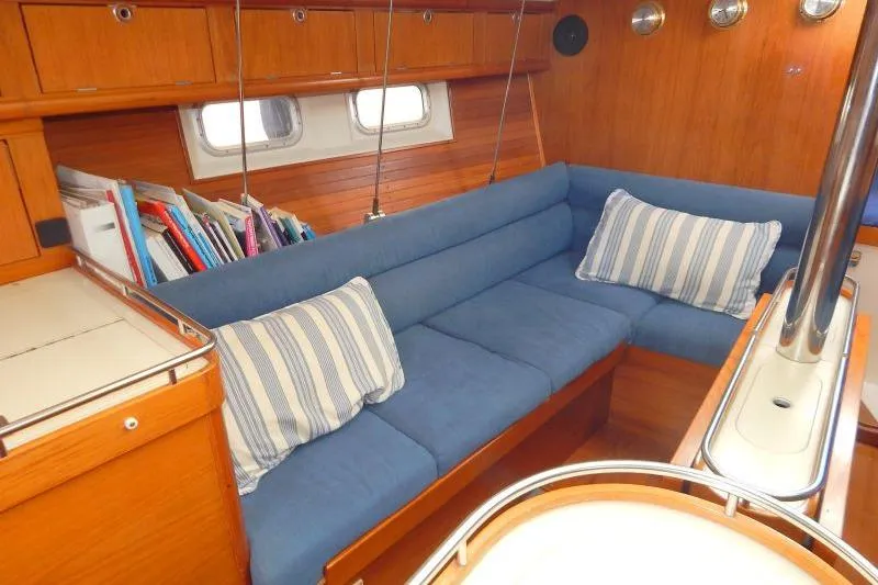 Slide: The Image of Cozy interior of 1997 Etap 38i sailboat with blue cushions and wooden finish. - 28