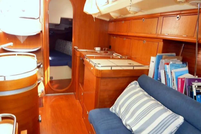 Slide: The Image of Interior of 1997 Etap 38i sailboat with wooden cabinetry and cozy seating area. - 29