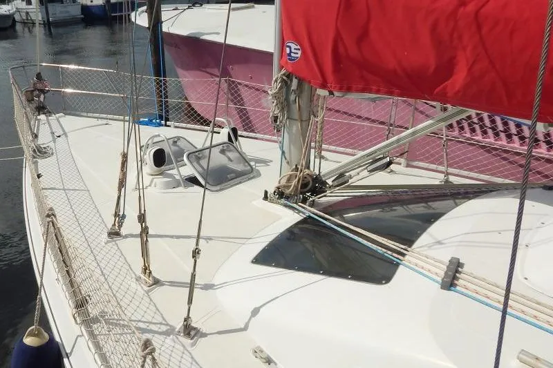 Slide: The Image of 1997 Etap 38i sailboat with red sail, docked at marina. - 3