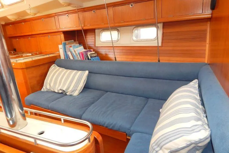 Slide: The Image of Interior of a 1997 Etap 38i yacht with blue cushions and wooden cabinetry. - 30