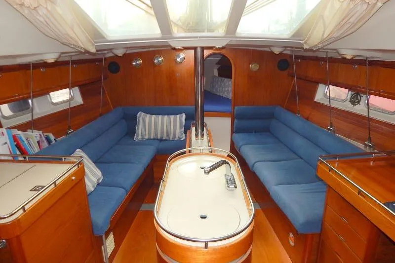Slide: The Image of Interior of a 1997 Etap 38i yacht with blue seating and wooden finishes. - 31