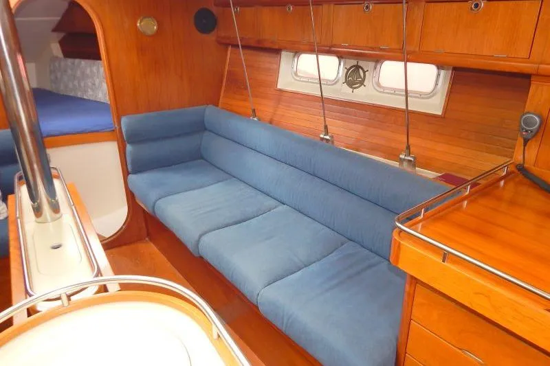 Slide: The Image of Interior of 1997 Etap 38i yacht with blue seating and wooden finishes. - 32
