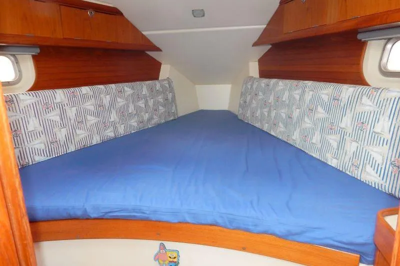 Slide: The Image of Cozy cabin interior of a 1997 Etap 38i sailboat with blue bedding. - 33