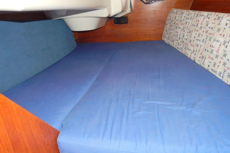 Slide: The Image of Interior cabin of a 1997 Etap 38i sailboat with blue bedding. - 34