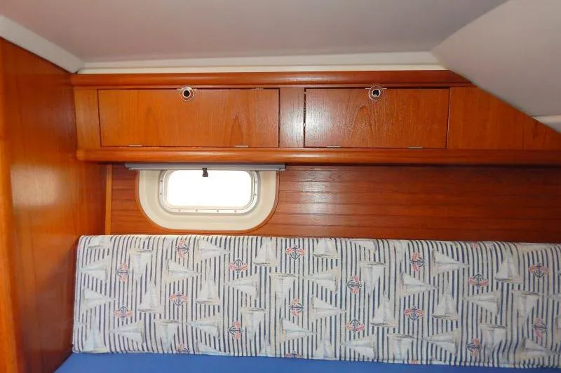 Slide: The Image of Interior of a 1997 Etap 38i yacht with wooden cabinets and patterned upholstery. - 36