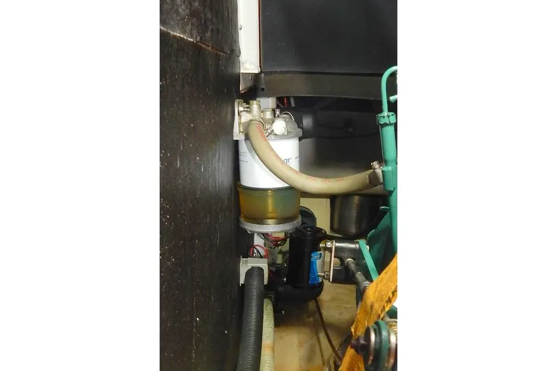 Slide: The Image of Engine compartment of a 1997 Etap 38i sailboat, featuring fuel filter and hoses. - 37