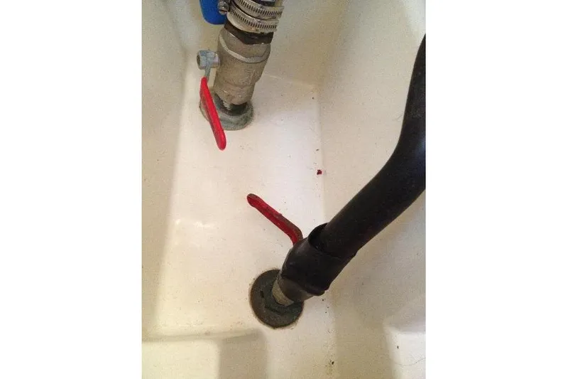 Slide: The Image of Interior plumbing of a 1997 Etap 38i sailboat with red-handled valves. - 43