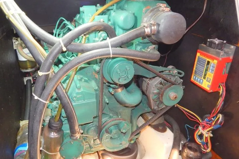 Slide: The Image of Engine compartment of a 1997 Etap 38i sailboat, featuring hoses and wiring. - 48