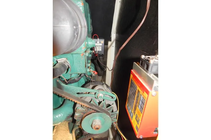 Slide: The Image of Engine compartment of a 1997 Etap 38i sailboat, featuring mechanical components and wiring. - 49