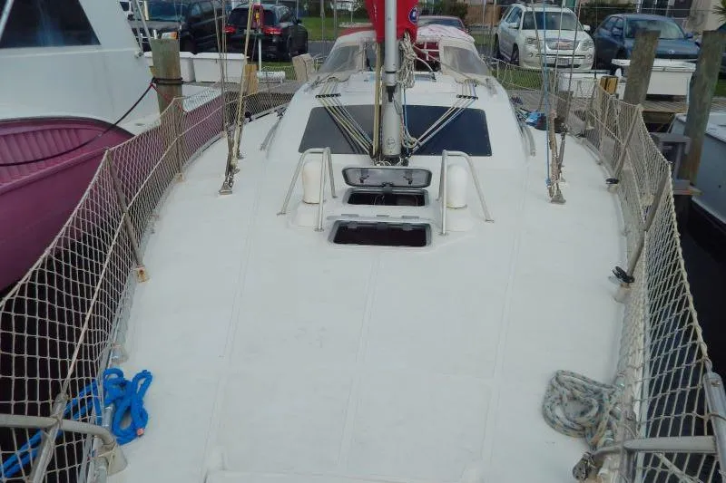 Slide: The Image of 1997 Etap 38i sailboat deck with rigging and safety netting in a marina. - 6
