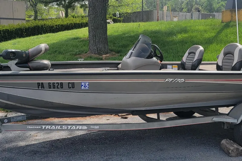 Slide: The Image of 2005 Tracker Pro Team 175 boat on trailer, parked outdoors with green grass background. - 13