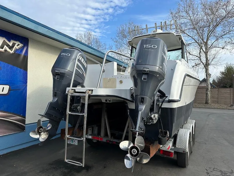 Slide: The Image of Glacier Bay 2680 Coastal Runner 2000 with twin outboard engines. - 11