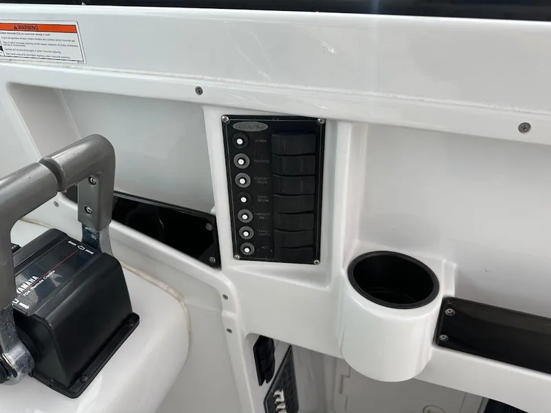 Slide: The Image of Dashboard of Glacier Bay 2680 Coastal Runner 2000 with switches and cup holder. - 30