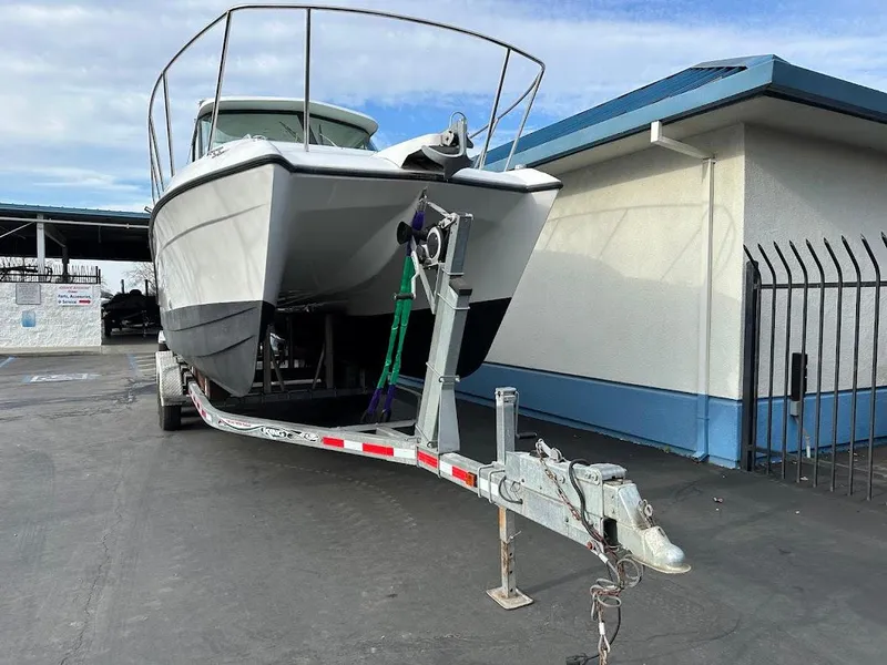 Slide: The Image of Glacier Bay 2680 Coastal Runner 2000 on trailer near building. - 5