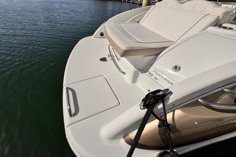 Slide: The Image of 2012 Formula 290 Sun Sport boat docked on calm water. - 10
