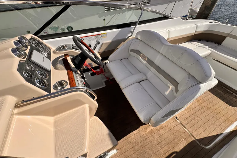 Slide: The Image of 2012 Formula 290 Sun Sport boat interior with steering wheel and white seating. - 14