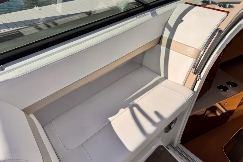 Slide: The Image of 2012 Formula 290 Sun Sport boat interior with white seating and cup holders. - 15