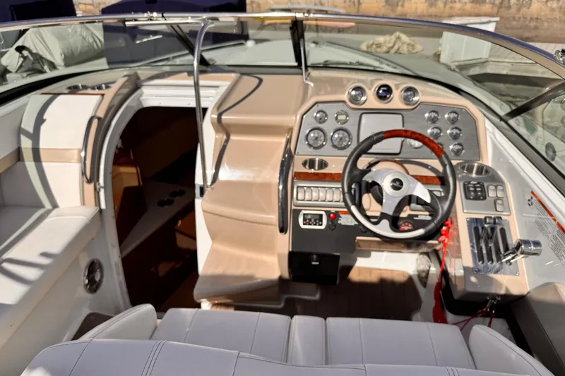 Slide: The Image of 2012 Formula 290 Sun Sport boat cockpit with steering wheel and control panel. - 17