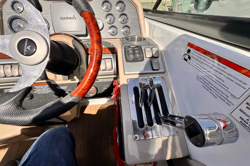 Slide: The Image of 2012 Formula 290 Sun Sport dashboard with steering wheel, controls, and Garmin display. - 21