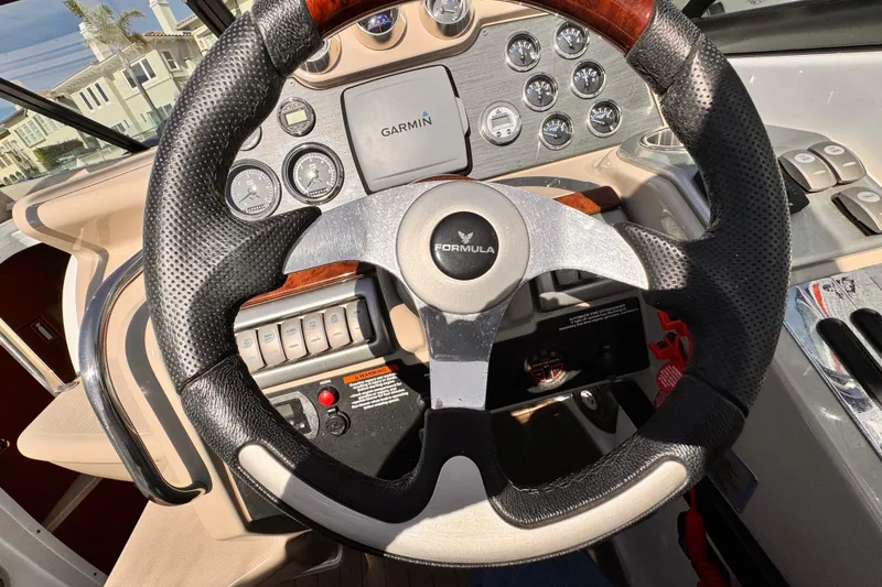 Slide: The Image of Steering wheel and dashboard of 2012 Formula 290 Sun Sport boat with Garmin display. - 22