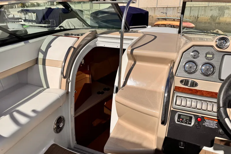 Slide: The Image of 2012 Formula 290 Sun Sport boat interior with dashboard and cabin entrance. - 24