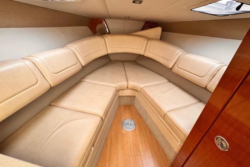 Slide: The Image of 2012 Formula 290 Sun Sport cabin interior with beige seating and wood accents. - 26