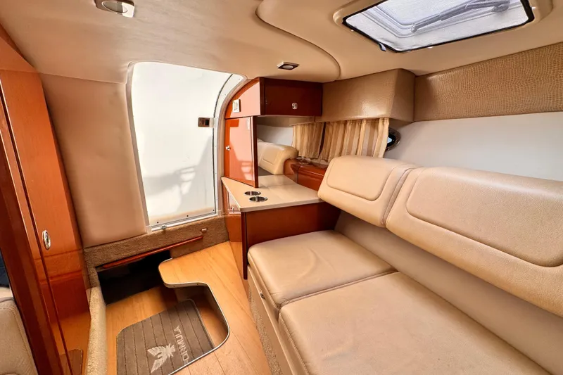 Slide: The Image of Interior of 2012 Formula 290 Sun Sport boat with beige seating and wooden accents. - 28