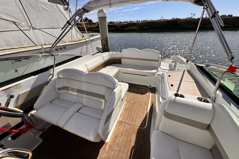 Slide: The Image of 2012 Formula 290 Sun Sport boat interior with white seating and wood flooring. - 31