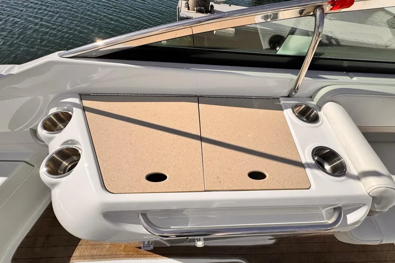 Slide: The Image of 2012 Formula 290 Sun Sport boat with cup holders and storage compartment. - 32