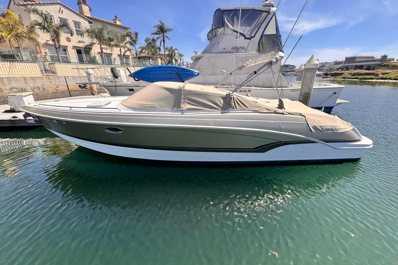 Slide: The Image of 2012 Formula 290 Sun Sport boat docked at marina, featuring sleek design and spacious seating. - 4