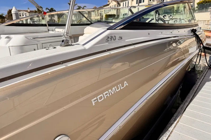 Slide: The Image of 2012 Formula 290 Sun Sport boat docked, showcasing sleek design and branding. - 5