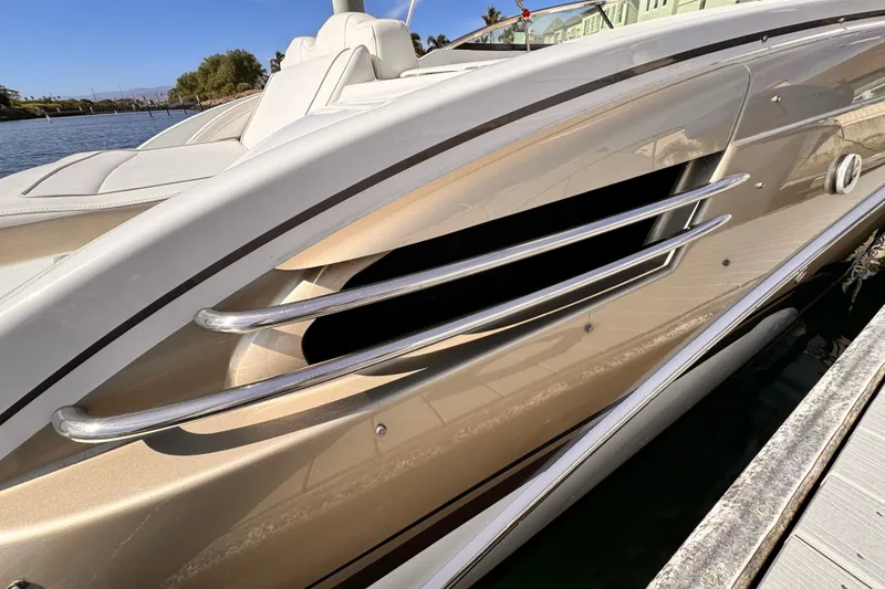 Slide: The Image of 2012 Formula 290 Sun Sport boat side view with sleek metallic design and chrome accents. - 6