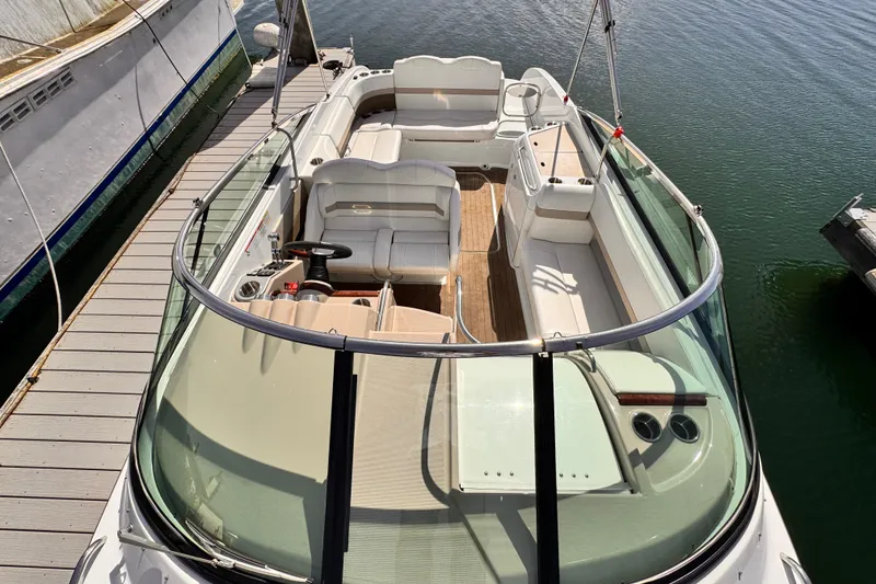 Slide: The Image of 2012 Formula 290 Sun Sport boat docked, featuring spacious seating and sleek design. - 7